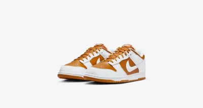 A pair of Nike Dunk Low sneakers on a white background.