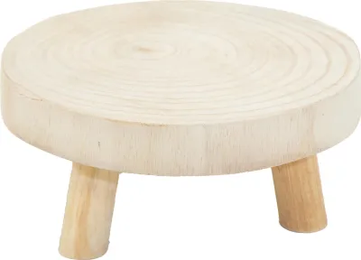 A small, round wooden plant stand with three legs.