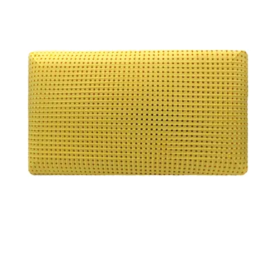 A yellow pillow with a perforated surface is shown against a white background.