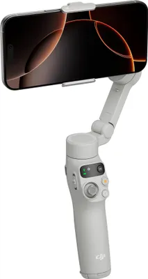 A smartphone is mounted on a white gimbal stabilizer.