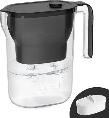 A clear water filter pitcher with a black lid and filter basket, filled with water.