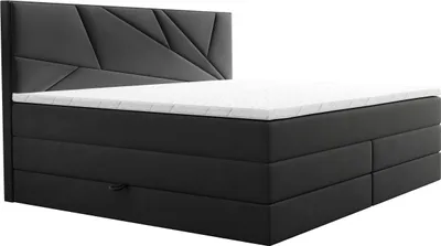 A dark grey boxspring bed with a white mattress and a geometric headboard, shown from a side angle against a white background.