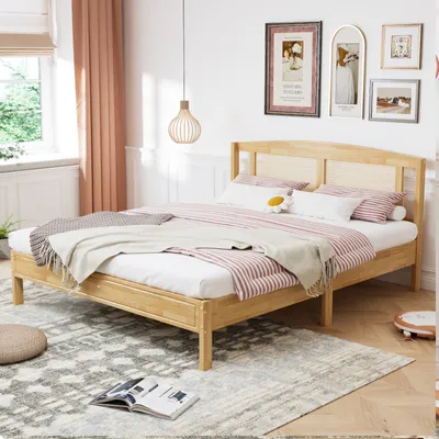 A bedroom scene with a bed, rug, and wall art.