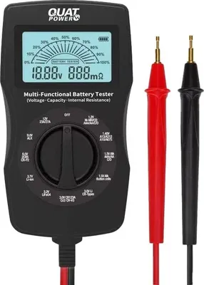 A black multi-functional battery tester with red and black test leads, displayed on a white background.