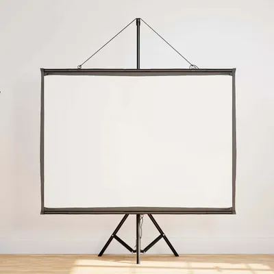 A white projection screen on a tripod stand against a white wall.