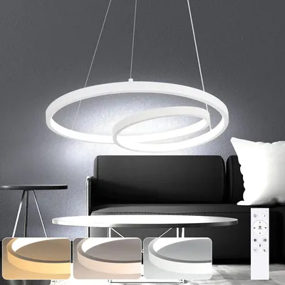 A modern white pendant light hangs above a coffee table and sofa in a living room setting.