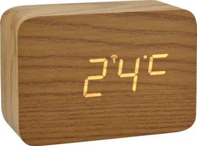 A digital clock with a wood-like finish displaying the temperature.