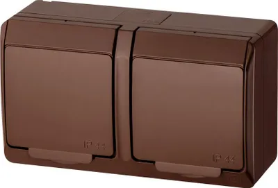 A brown, double electrical outlet with protective covers.