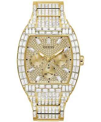 A close-up studio shot of a gold-colored Guess watch with crystal embellishments.