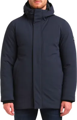 A man wearing a navy blue parka jacket.