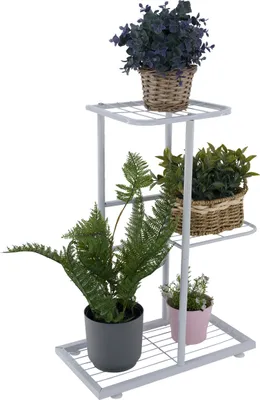 A white metal plant stand with multiple tiers, holding several potted plants.
