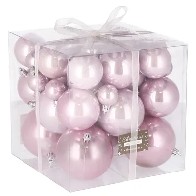 A clear, well-lit studio shot of a box of pink Christmas ornaments.