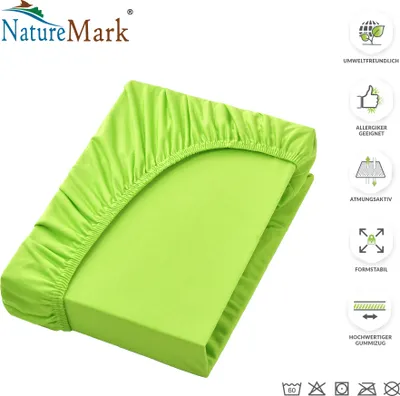 A folded green fitted sheet is shown on a white background, with various product feature icons and text on the right side.