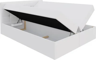 A white boxspring bed with its storage compartment open, revealing the interior.