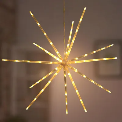 A star-shaped LED light fixture hangs against a blurred background.