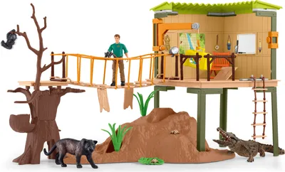 A toy playset depicting a wildlife research station with various animal figures and a human figure.