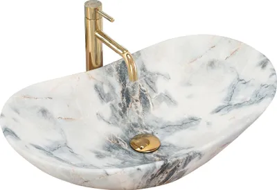 A marble basin with a gold faucet.