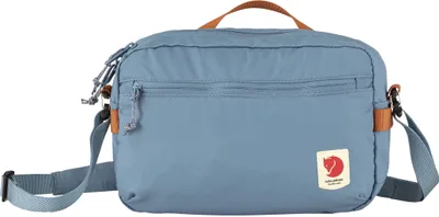 A blue Fjällräven crossbody bag is shown against a white background.