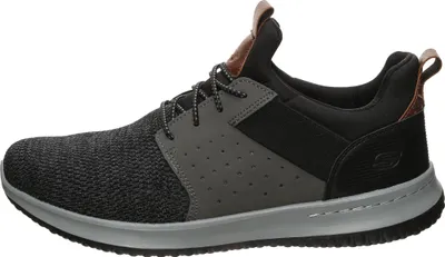 A side view of a single black and gray sneaker.