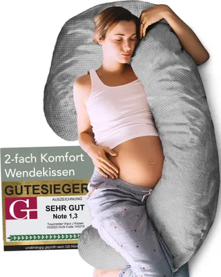 A pregnant woman is sleeping while hugging a large gray pillow. There is a marketing badge on the left side of the image.