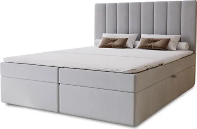 A bed with a headboard, mattress, and pillows, shown against a white background.
