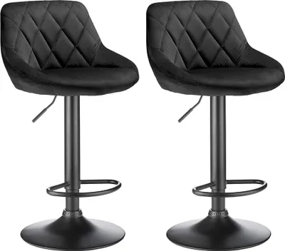 Two black velvet bar stools with diamond tufting and adjustable height.