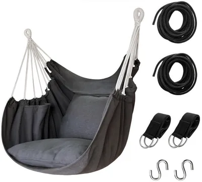 A dark gray hanging chair with a pillow and a side pocket, along with accessories like ropes, straps with rings, and S-hooks, presented on a white background.