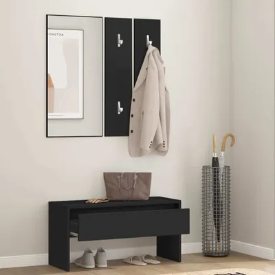 A hallway scene with a black wooden storage bench, a mirror, coat hooks, and an umbrella stand.