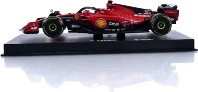 A model of a red Formula 1 race car on a black display stand.