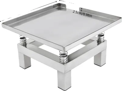 A stainless steel platform with springs and legs, likely for vibration or weighing.