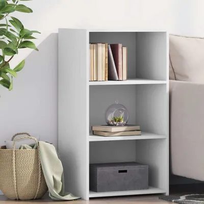 A white sideboard with three shelves, decorated with books, a terrarium, and a storage box. A basket and a plant are visible to the left.