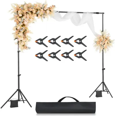 A wedding arch setup with floral decorations, fabric drapes, and photography clamps, displayed on a white background.