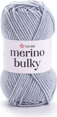A ball of light gray yarn with a white label.