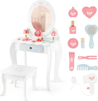 A white wooden children's vanity table and stool set with various toy makeup accessories.
