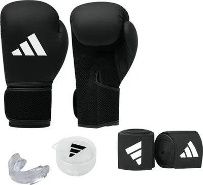 A set of boxing equipment including gloves, hand wraps, and a mouthguard, all branded with the Adidas logo.