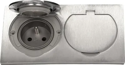 A close-up, top-down view of a recessed electrical outlet with a hinged cover.