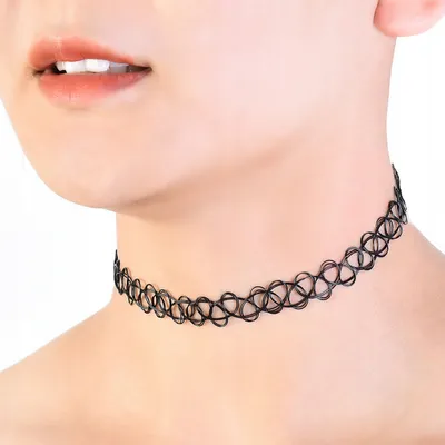 Close-up of a person wearing a black choker necklace.