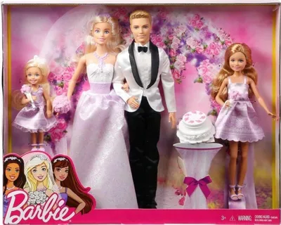 A Barbie wedding gift set featuring dolls in wedding attire, a cake, and a floral backdrop, presented in its retail packaging.
