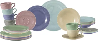 A collection of colorful ceramic plates and cups arranged on a white background.