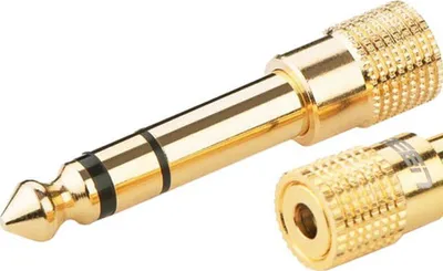 A close-up studio shot of a gold audio adapter.