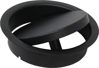 A black circular object with a hinged lid, likely a waste disposal or ventilation component.