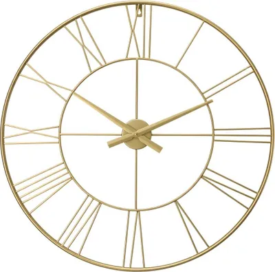 A close-up, front-facing shot of a gold-colored, metal wall clock with Roman numerals.