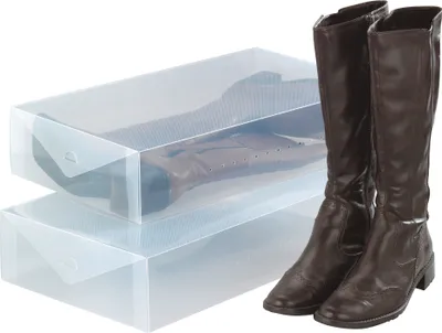 Two clear plastic boot storage boxes are stacked, with a pair of brown leather boots placed next to them.