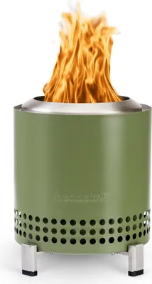 A green Solo Stove Mesa XL fire pit with flames burning inside, set against a white background.