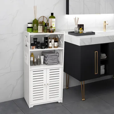 A white bathroom cabinet filled with toiletries and towels, placed next to a black vanity with a marble countertop.