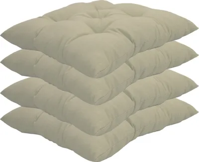 A stack of four beige seat cushions.