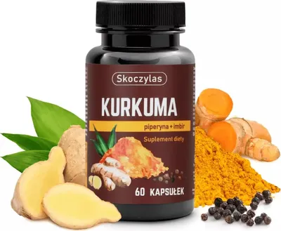A bottle of Skoczylas Kurkuma supplement surrounded by fresh turmeric roots, ginger, and black peppercorns.