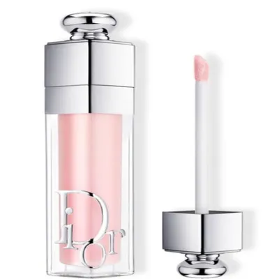 A Dior Addict Max lipstick in a clear tube with a silver cap and applicator, showing the pink product inside.