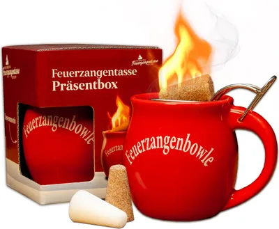 A red Feuerzangentasse (fire tongs mug) set with a box, a mug with a sugar cube on fire, and two sugar cones.