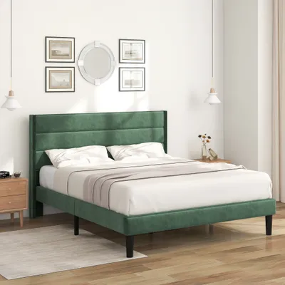 A dark green upholstered bed with white bedding is shown in a bedroom setting.